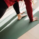 a person standing on a yoga mat on the floor