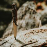 gray steel knife with brown handle